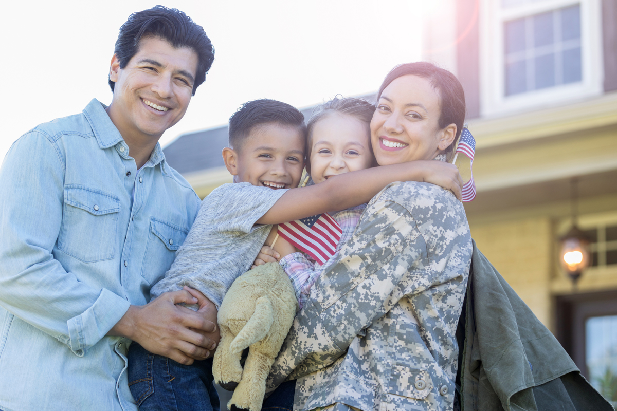Man-and-his-children-are-reunited-with-military-mom-stock-photo